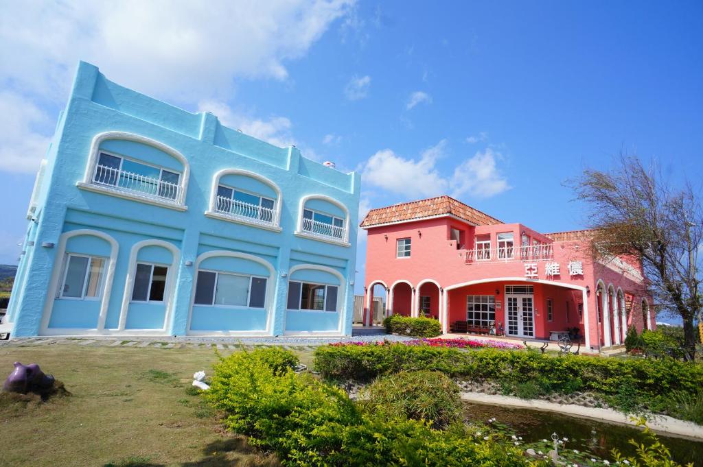 a group of colorful houses in a yard at Kenting Avignon in Hengchun South Gate