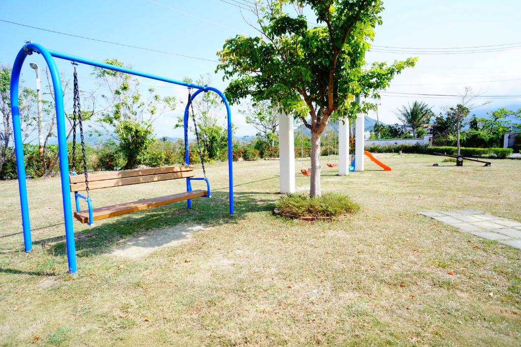 an empty park with a bench and a swing at Kenting Avignon in Hengchun South Gate