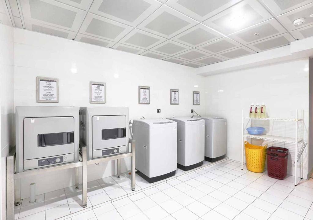 a kitchen with three refrigerators in a room at Royal Group Hotel Minghua Branch in Kaohsiung