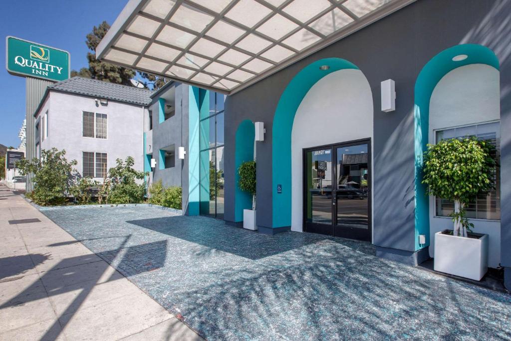 a building with blue arches and a glass door at Quality Inn Near Hollywood Walk of Fame in Los Angeles