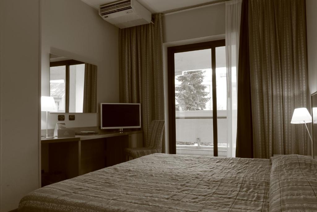 Postel nebo postele na pokoji v ubytování Hotel Romanisio
