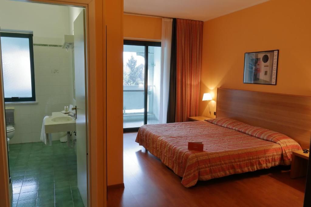 Postel nebo postele na pokoji v ubytování Hotel Romanisio