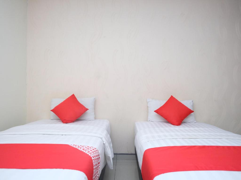 Postel nebo postele na pokoji v ubytování Hotel De' Tees, Masai Utama