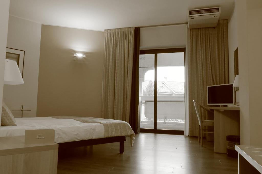 Postel nebo postele na pokoji v ubytování Hotel Romanisio