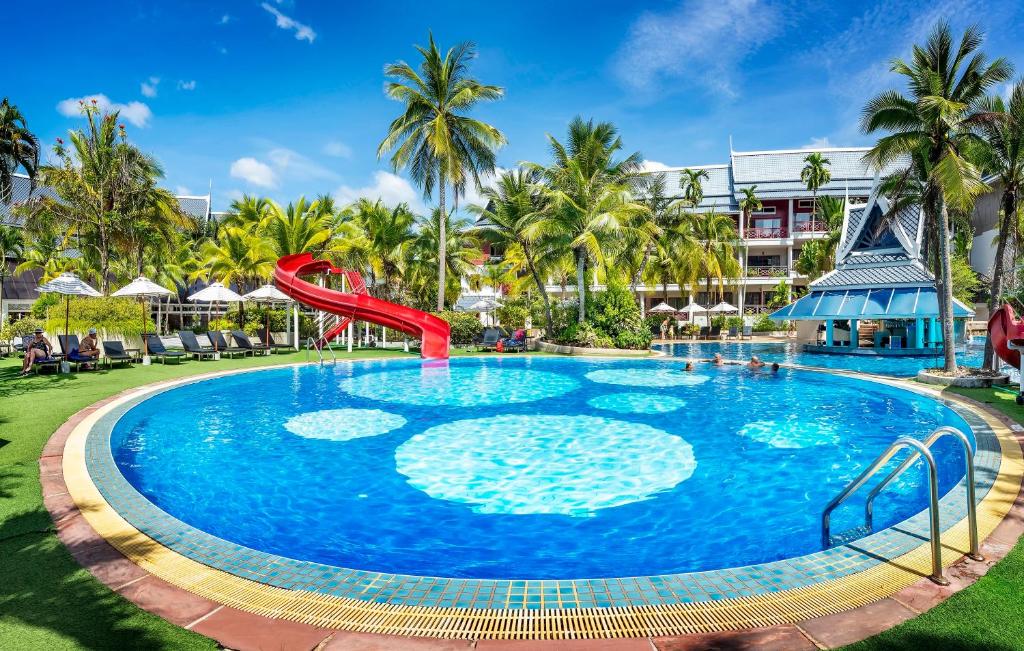 a pool at the resort with a slide at Chada Thai Village in Ao Nang Beach