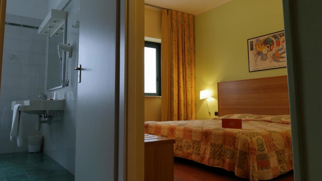 Postel nebo postele na pokoji v ubytování Hotel Romanisio