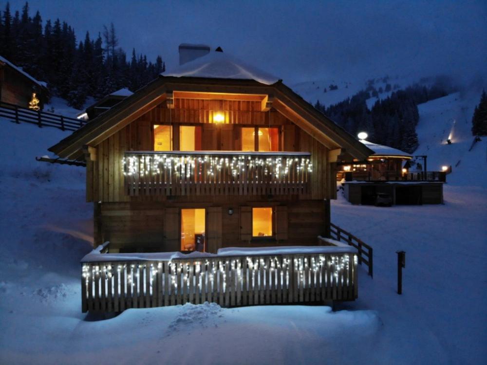 a log cabin with lights on it in the snow at Talhütte App.2 in Hinteralm