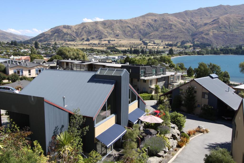 an aerial view of a house with mountains in the background at The Moorings Motel and Apartments in Wanaka