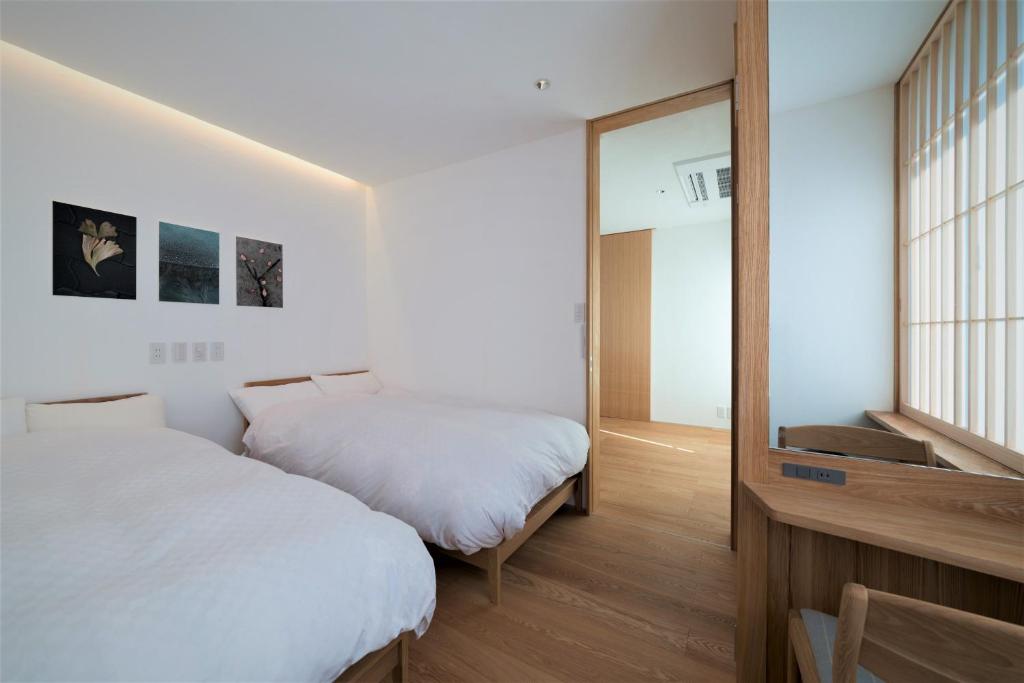 Postel nebo postele na pokoji v ubytování Komatsu Residences