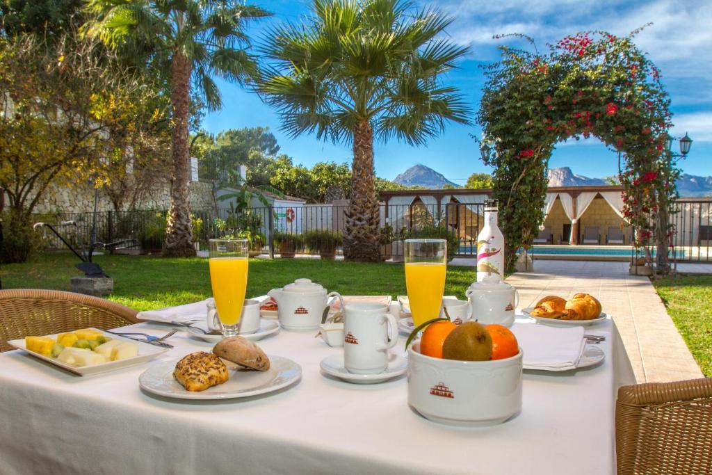 a white table with food and drinks on it at Hotel Tossal d'Altea in Altea