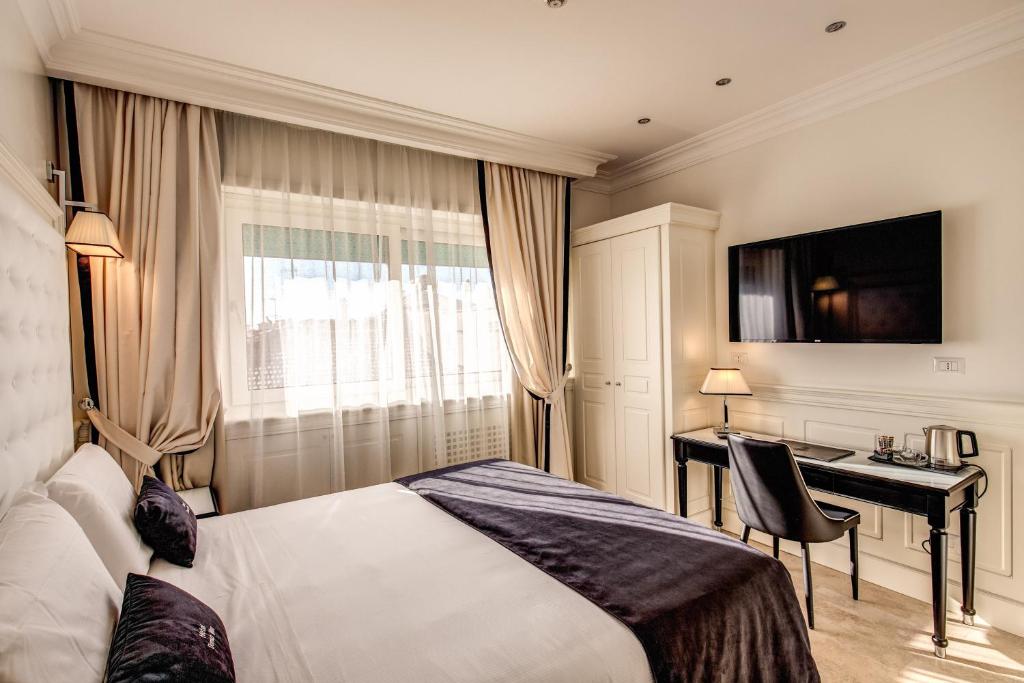 Postel nebo postele na pokoji v ubytování Hotel Domus Mea