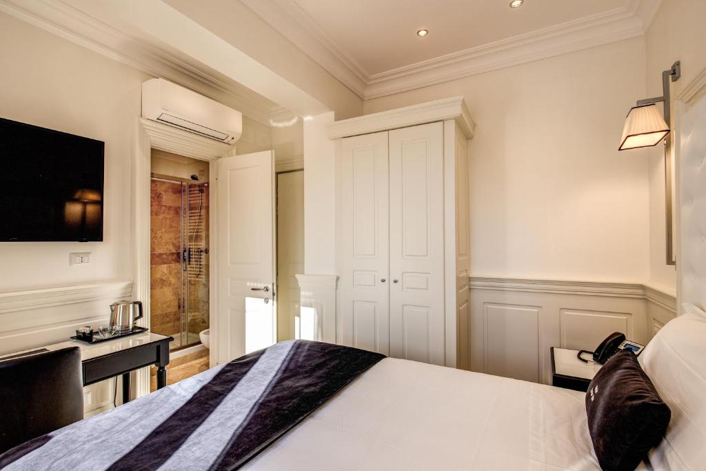 Postel nebo postele na pokoji v ubytování Hotel Domus Mea