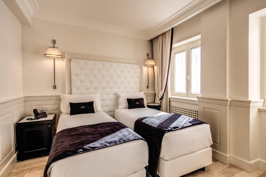 Postel nebo postele na pokoji v ubytování Hotel Domus Mea
