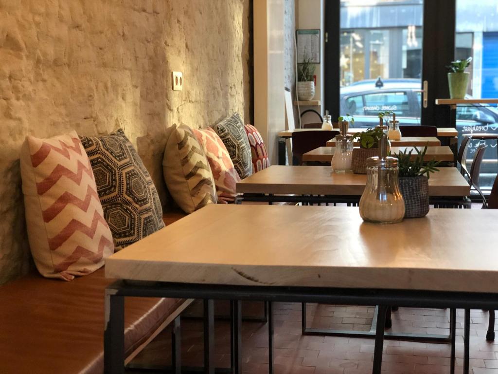 a row of tables in a restaurant with pillows at Mañana Mañana in Antwerp