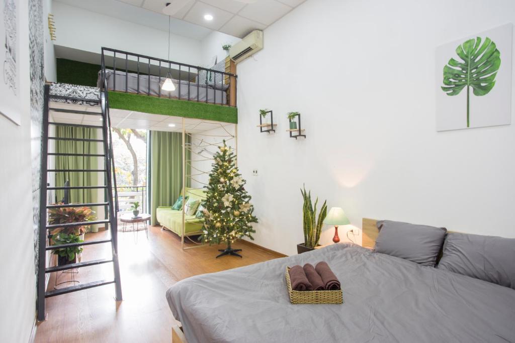 a bedroom with a loft bed and a christmas tree at KemKay Homestay in Hanoi