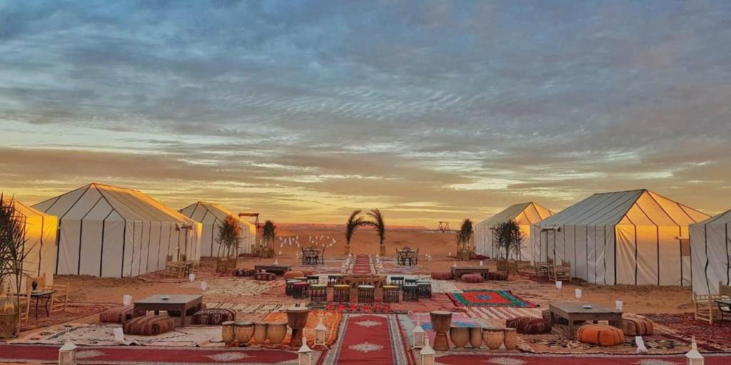 a group of white domes in a desert at Starry Desert Nights Camp in Merzouga
