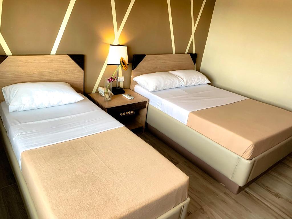 Postel nebo postele na pokoji v ubytování New Dawn Plus