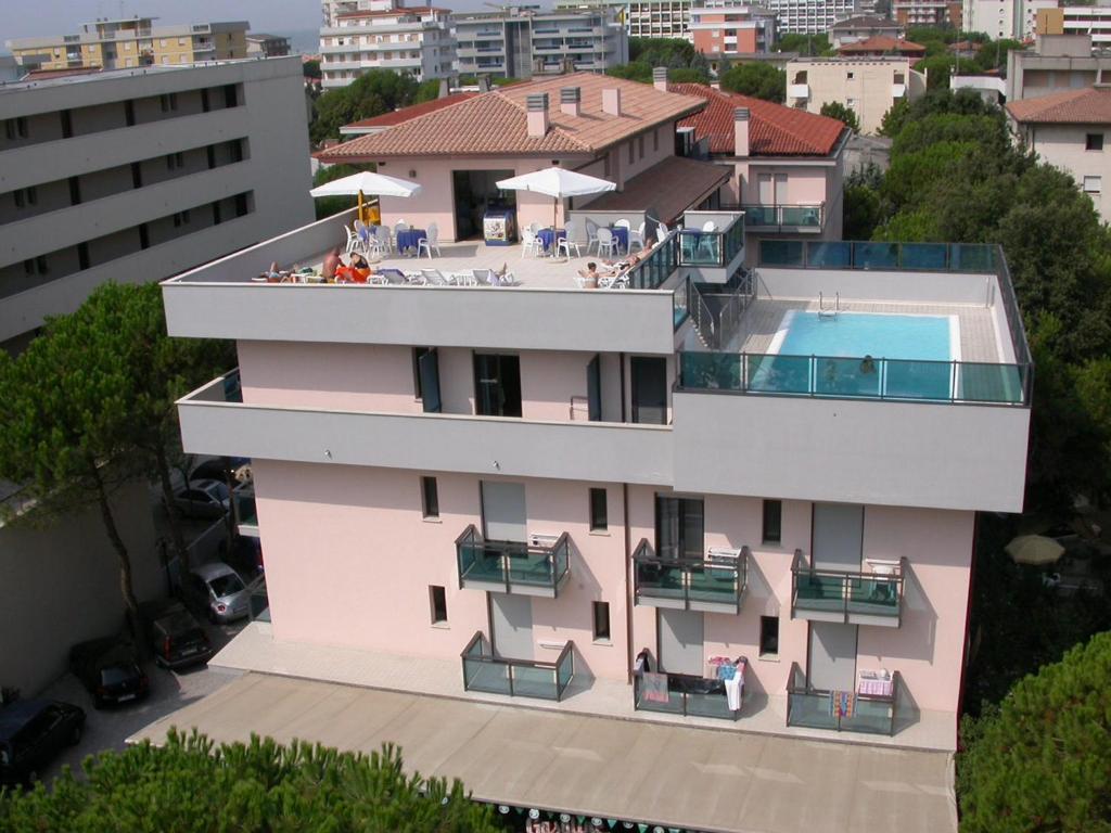 an aerial view of a building with a swimming pool at Olimpia Hotel & Aparthotel in Bibione