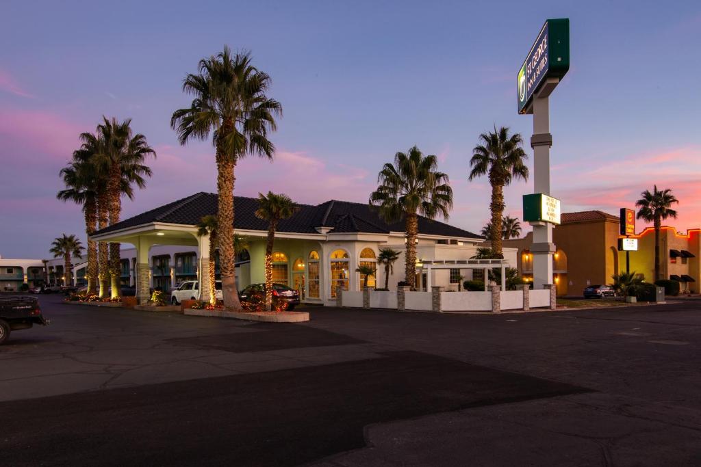 a gas station with palm trees in front of it at St. George Inn and Suites in St. George