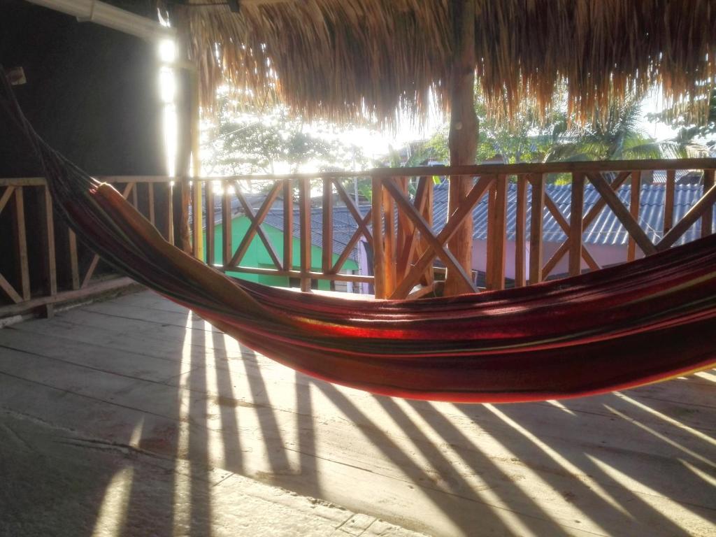 a hammock hanging from a straw umbrella on a porch at Rancho Mar in Rincón