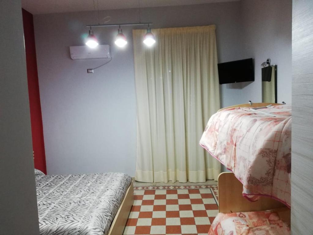 Postel nebo postele na pokoji v ubytování B&B Enjoy Ercolano