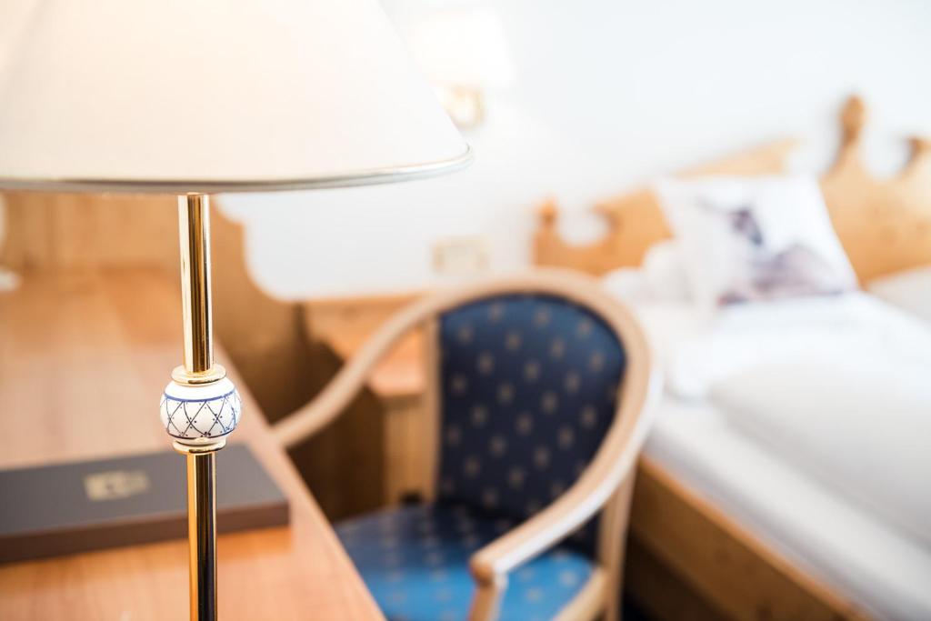 A bed or beds in a room at Alpenhotel Plaza
