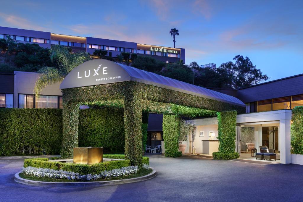 a large building with a clock on the front of it at Luxe Sunset Boulevard Hotel in Los Angeles