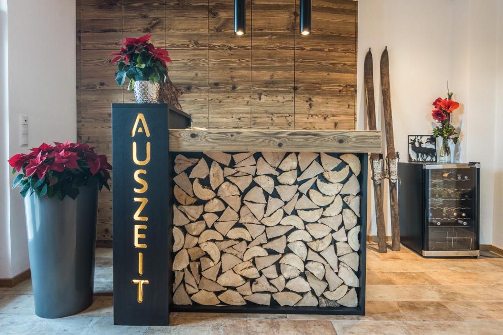 a log wall in a room with a sign at AusZeit in Oberammergau
