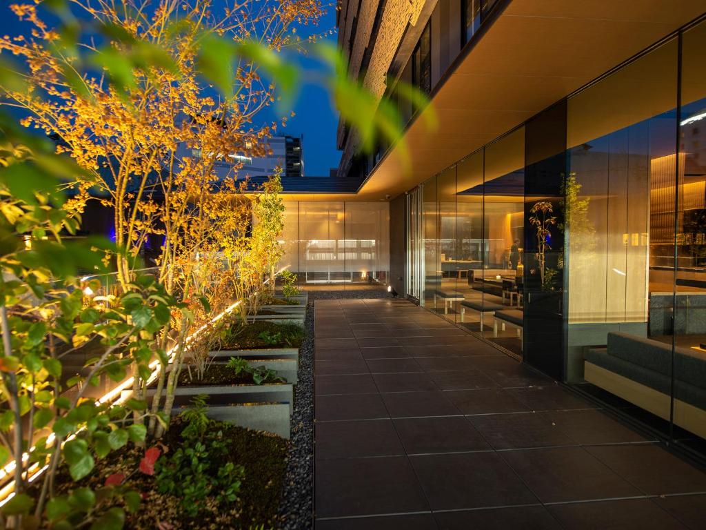 a walkway in front of a building with lights at Tokyu Stay Kyoto Sakaiza Shijo Kawaramachi in Kyoto