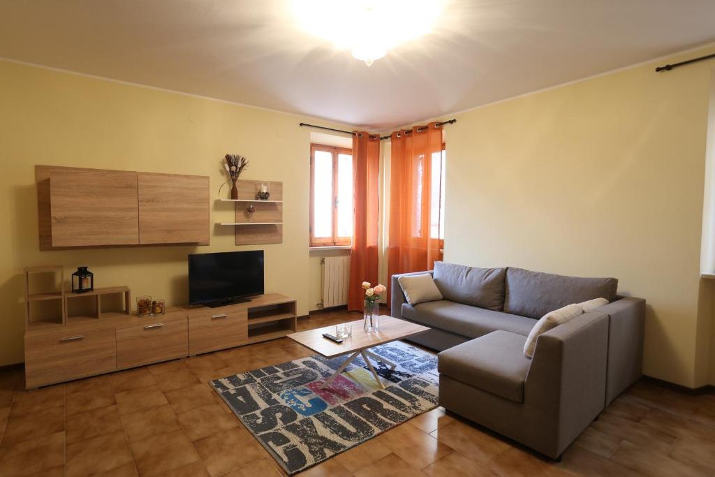 a living room with a couch and a television at La Dimora sul colle in Potenza Picena