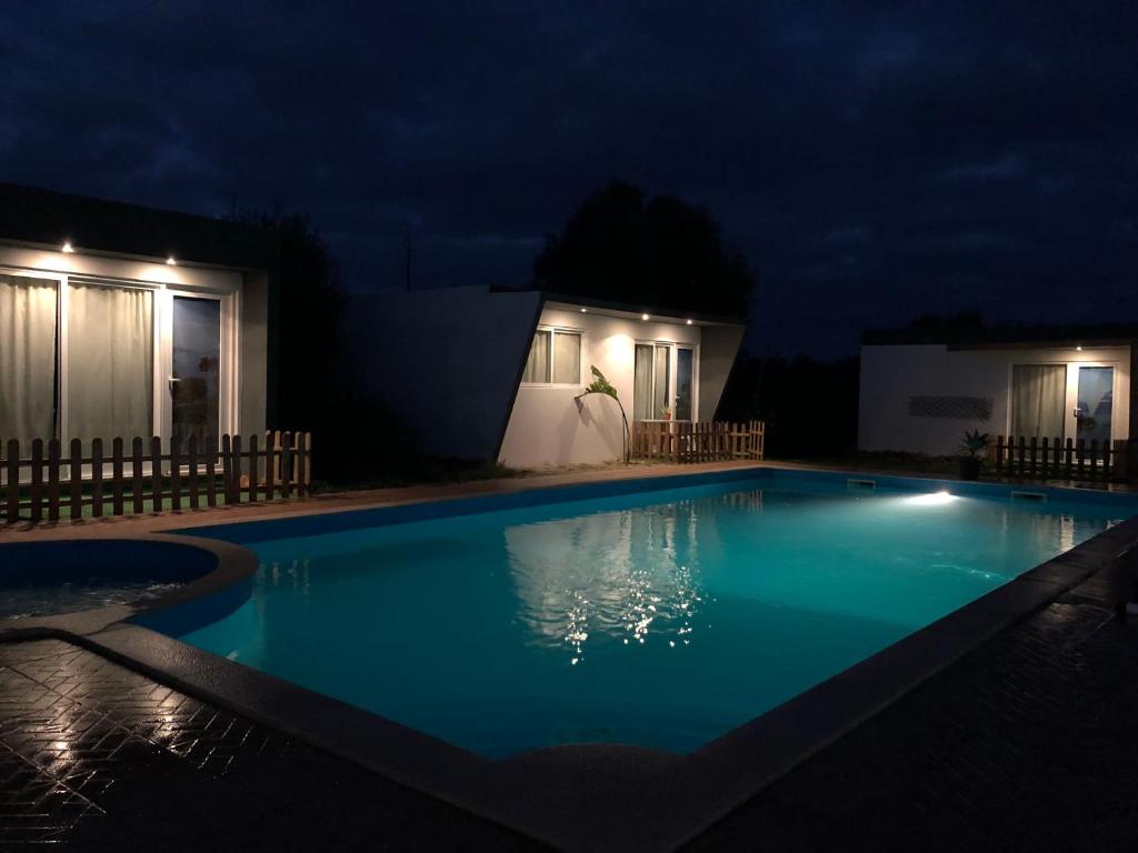 a swimming pool at night with lights on at Quinta da Joia in Silves
