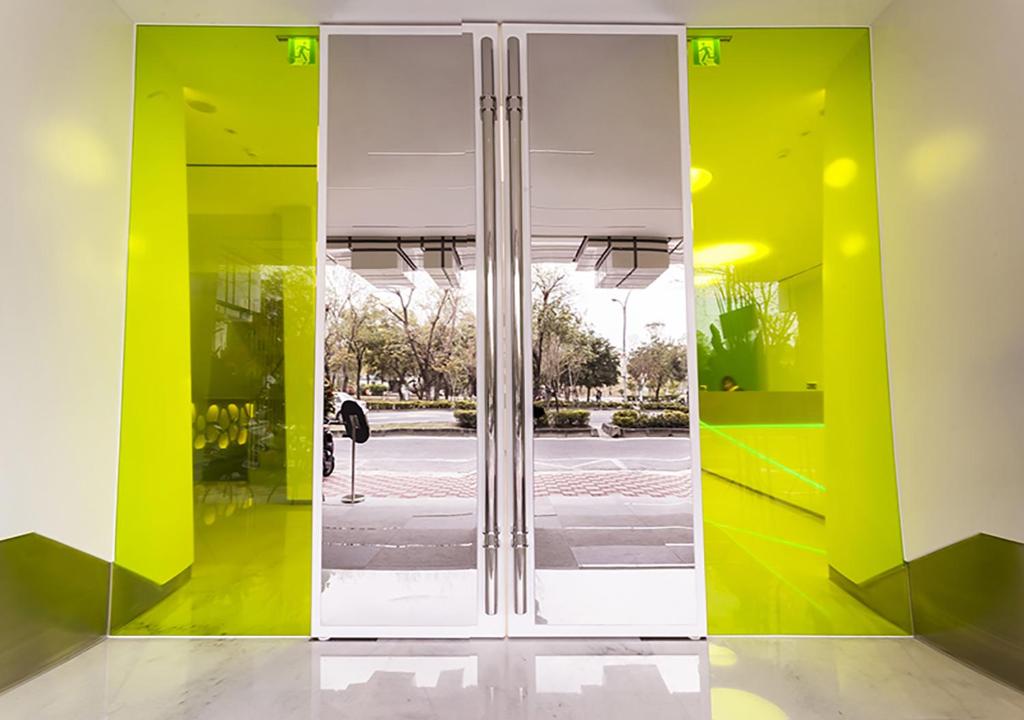 a large glass door in a room with yellow at Royal Hotel Group- Central Park Branch in Kaohsiung