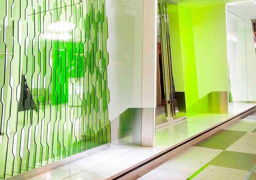 a room with green and white walls and mirrors at Royal Hotel Group- Central Park Branch in Kaohsiung