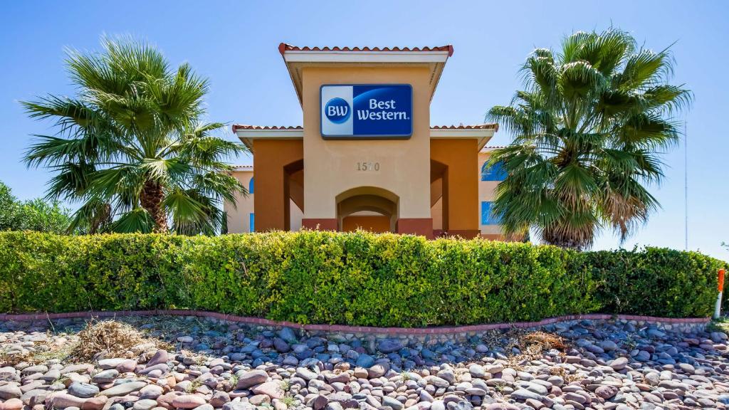 a sign in front of a building with palm trees at Best Western East El Paso Inn in Clint