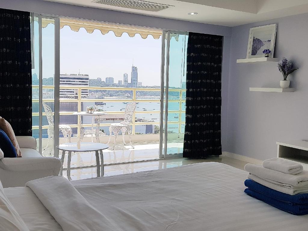 a bedroom with a bed and a view of a balcony at View Talay 6 Pattaya Beach by CANDO in Pattaya Central