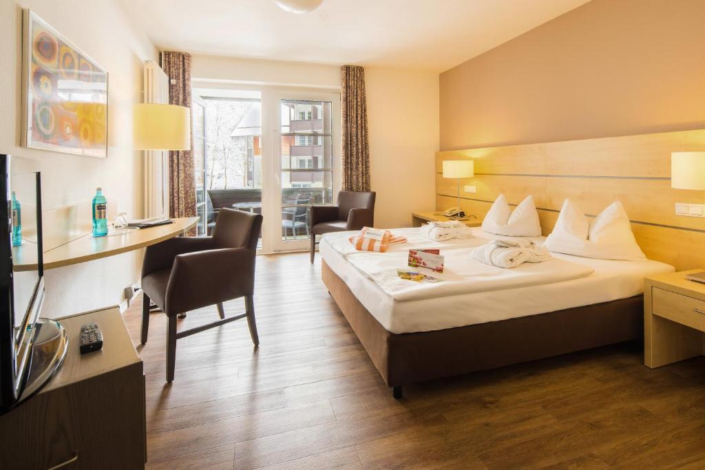Postel nebo postele na pokoji v ubytování relexa hotel Harz-Wald Braunlage GmbH