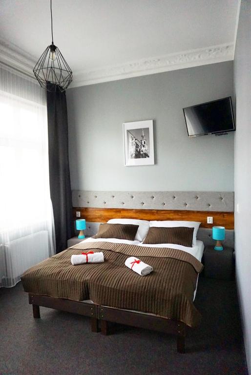 Postel nebo postele na pokoji v ubytování Expolis Residence - City Center MTP TARGI - 24h #betterthanyourEX