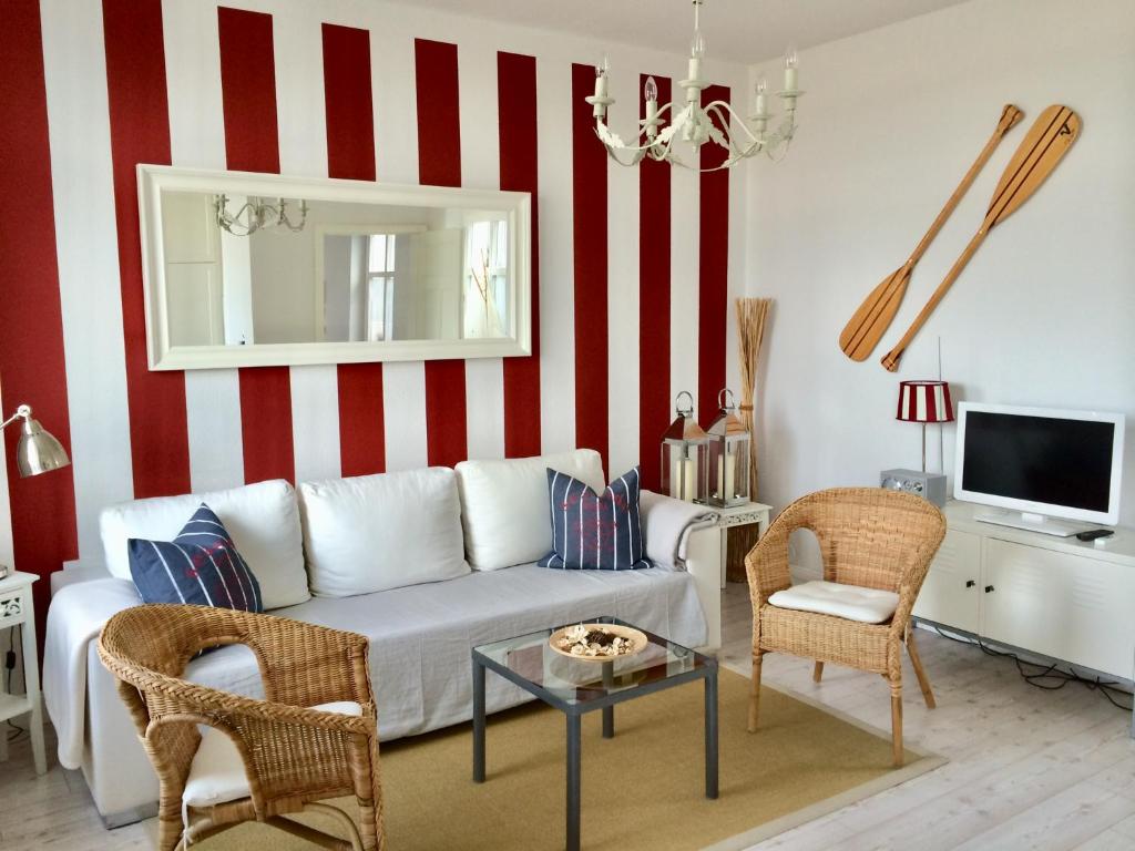 リーブニッツ・ダムガルテンにあるMÖWEの白いソファと赤と白のストライプが特徴のリビングルーム