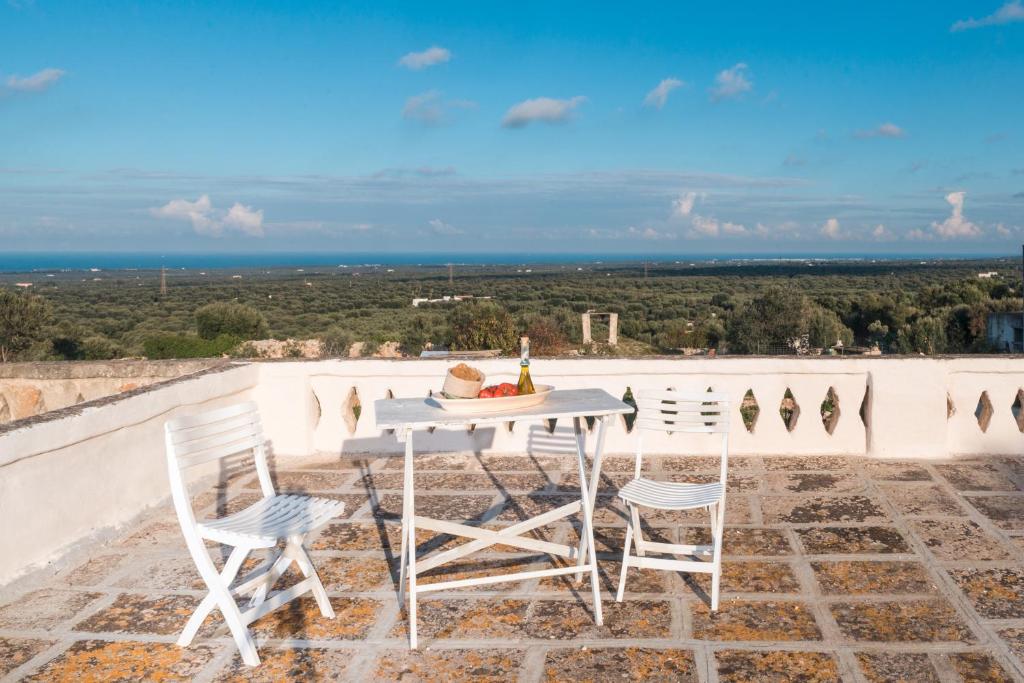 a table and chairs on a patio with a view at Sea and the City Apartments by Wonderful Italy in Ostuni