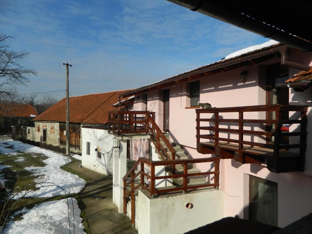 a house with wooden balconies on the side of it at Casa Juliana in Rîu Bărbat