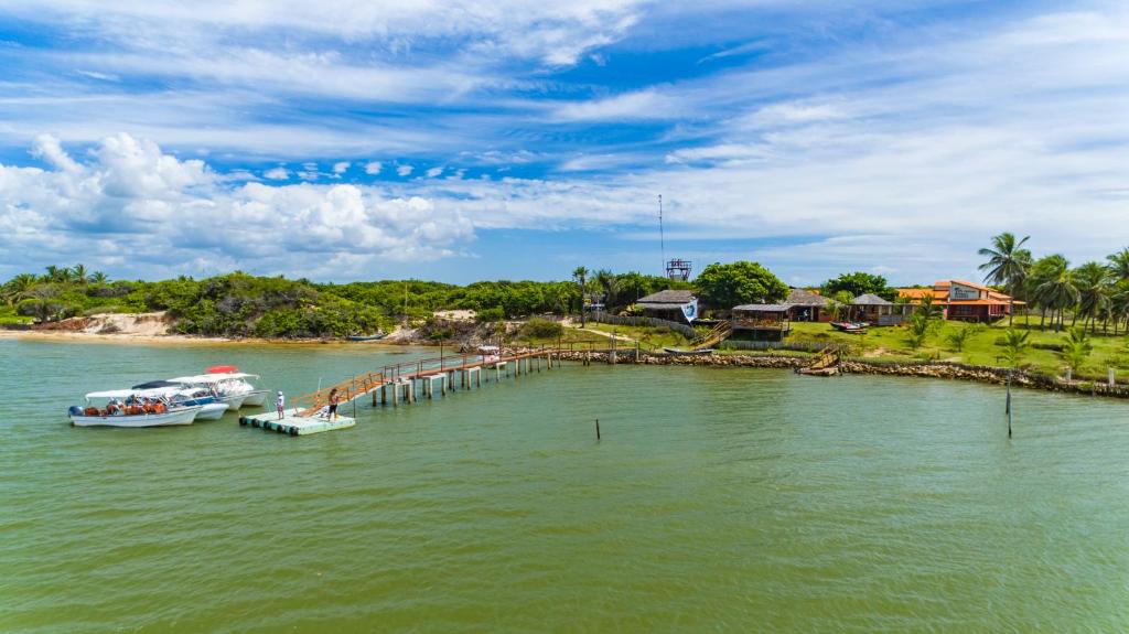 two boats are docked at a dock in the water at Casa de Caboclo in Canárias