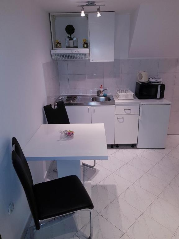 Kuchyň nebo kuchyňský kout v ubytování Apartments Minerva