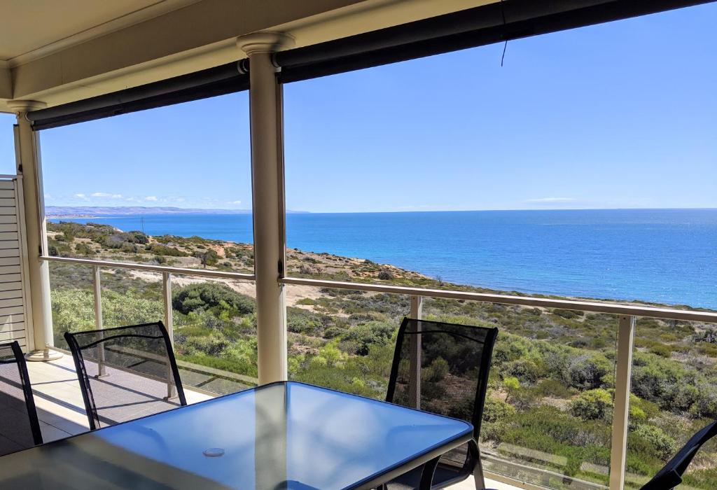 a view of the ocean from the balcony of a house at Ochre Point Beach House on Moana Seafront in Moana