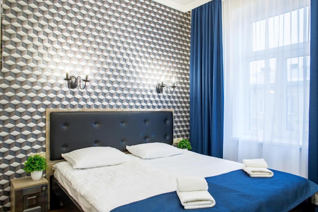 a bedroom with a bed with two towels on it at Mini Hotel Barvy Lvova on Horodotska St. in Lviv