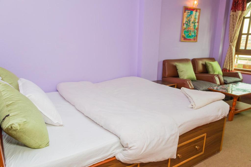 Postel nebo postele na pokoji v ubytování Swastik Guest House