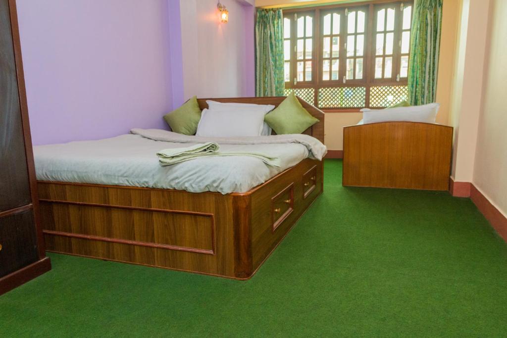 Postel nebo postele na pokoji v ubytování Swastik Guest House