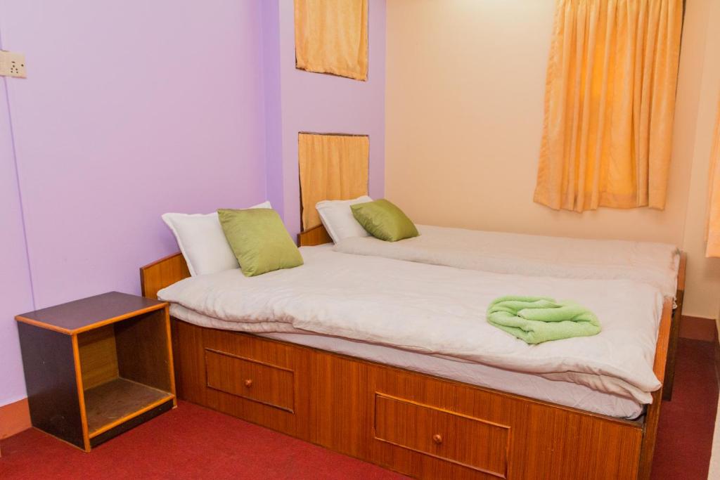 Postel nebo postele na pokoji v ubytování Swastik Guest House