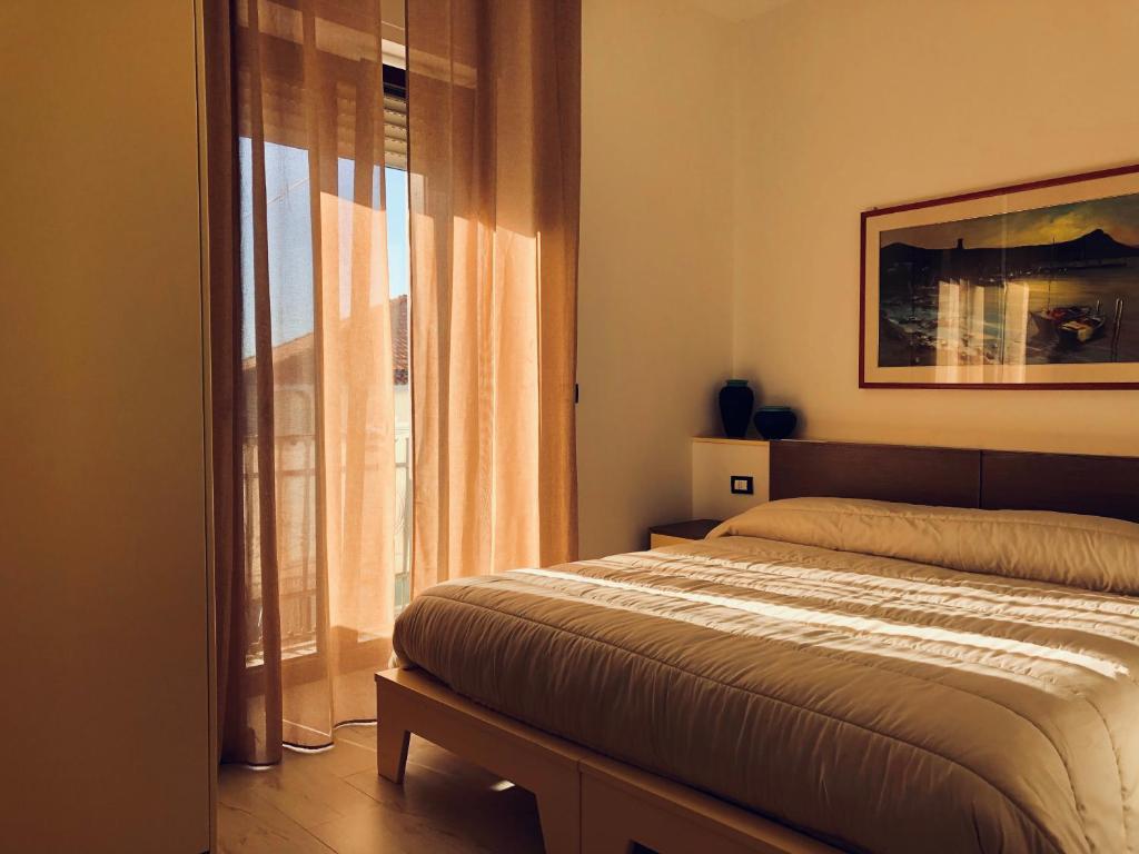 a bedroom with a bed and a window at Brezza Marina in Sapri