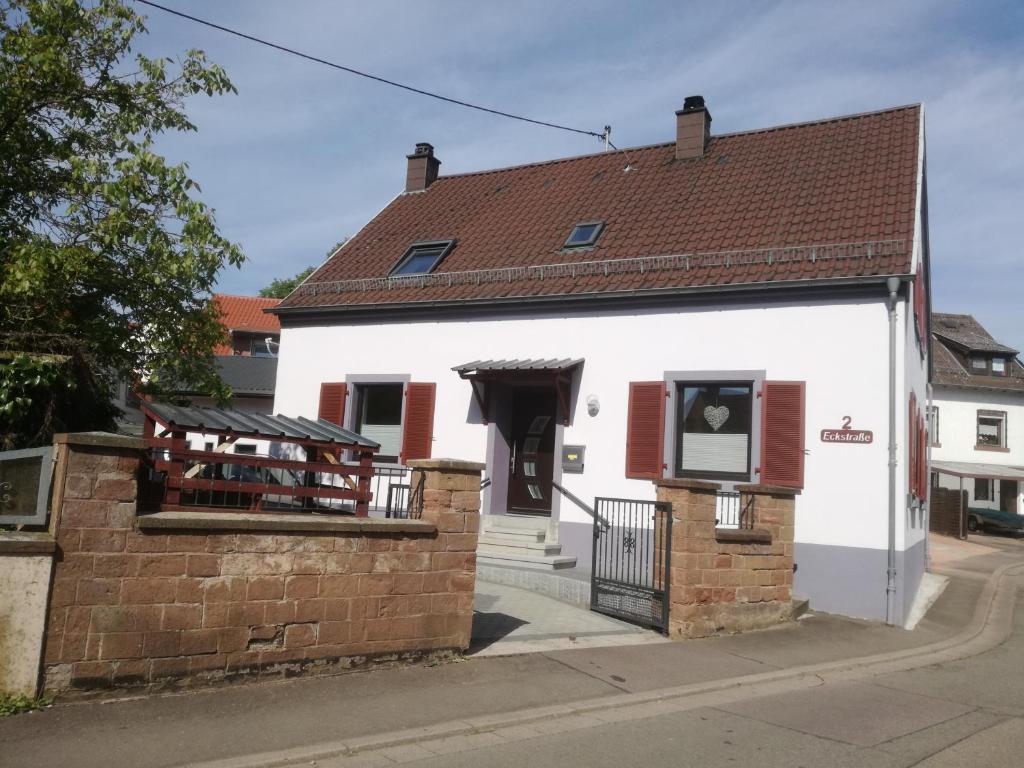 a white building with a brown roof at Haus - Anni in Blieskastel