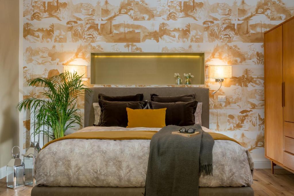 a bedroom with a large bed with a yellow pillow at Marvellous apt near Vatican in Rome